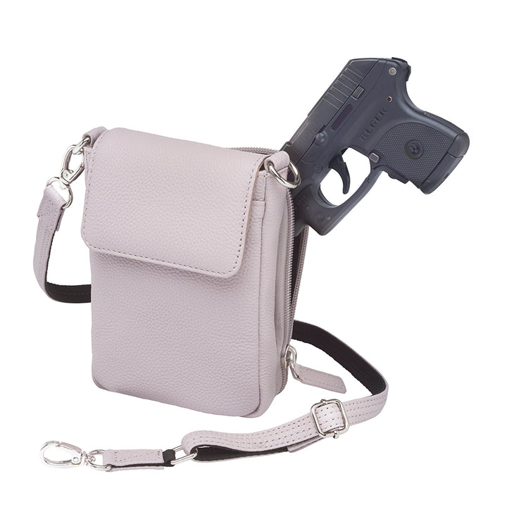 Lavender concealed carry crossbody phone pouch made from pebble grain American cowhide, designed for compact firearm storage with a slim, stylish profile.