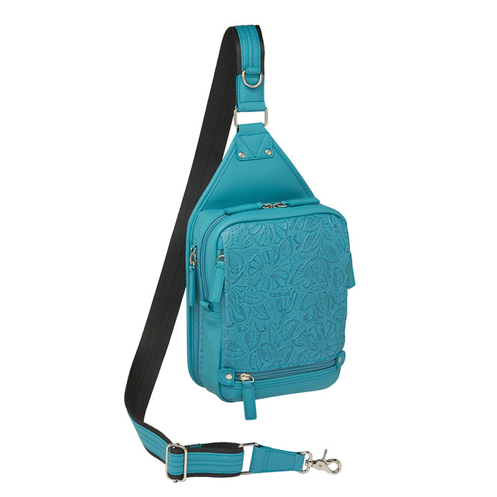 Mini Sling concealed carry backpack in turquoise, made from tooled pebble grain American cowhide. Features adjustable strap, secure gun compartment, and compact design for easy carry of essentials, ideal for compact firearms like Kahr 380 and Ruger LCP