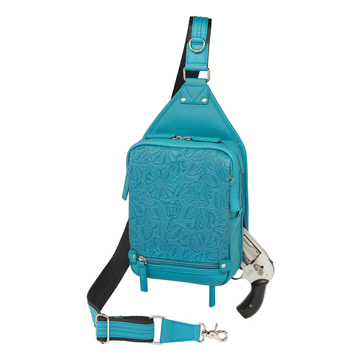Mini Sling concealed carry backpack in turquoise, made from tooled pebble grain American cowhide. Features adjustable strap, secure gun compartment, and compact design for easy carry of essentials, ideal for compact firearms like Kahr 380 and Ruger LCP