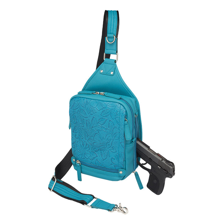 Mini Sling concealed carry backpack in turquoise, made from tooled pebble grain American cowhide. Features adjustable strap, secure gun compartment, and compact design for easy carry of essentials, ideal for compact firearms like Kahr 380 and Ruger LCP