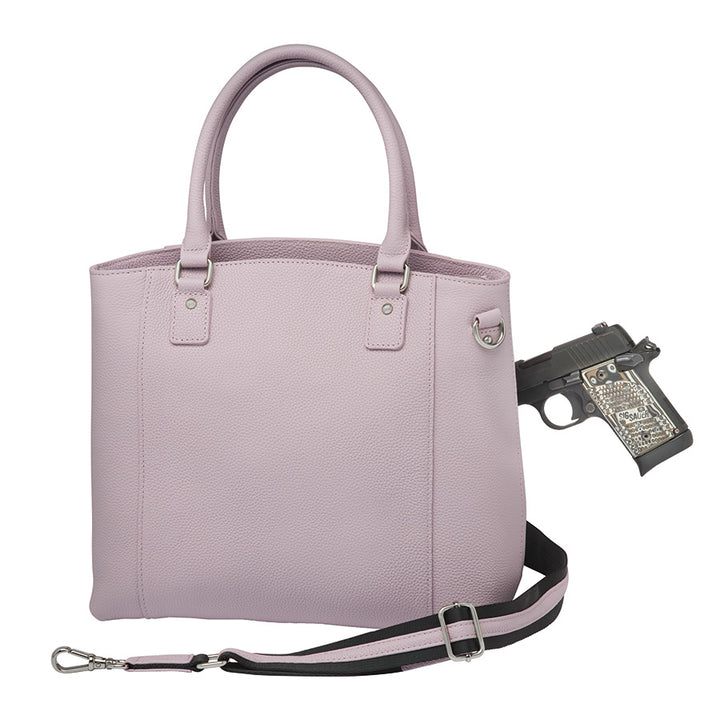 Elegant lavender Town Tote concealed carry purse made from top grain cowhide with pebble texture. Features spacious interior, RFID-blocking pocket, and hidden firearm compartment with dual zip access. Includes slash-resistant strap, chrome hardware, and room for tablets, water bottles, and everyday essentials