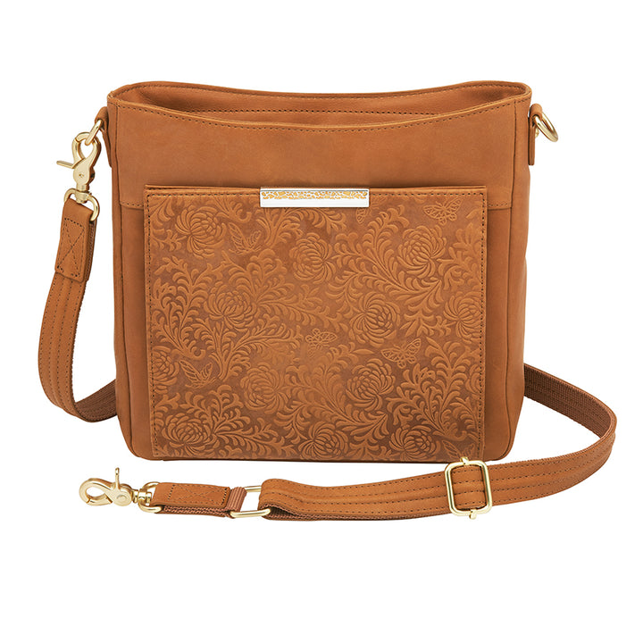 Slim tan concealed carry crossbody bag made from brushed USA cowhide, featuring RFID-blocking front organizer, slash-resistant adjustable strap, and fast-access top-draw gun compartment for left or right-hand draw.