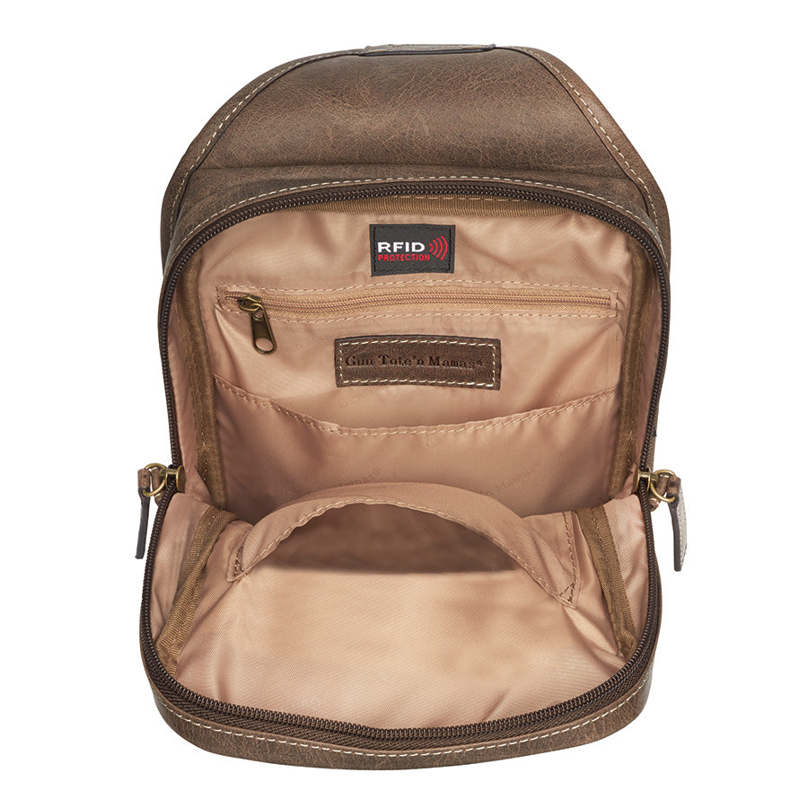 Compact brown mini sling concealed carry backpack made from distressed buffalo leather, designed for discreet, secure, and comfortable everyday firearm carry.