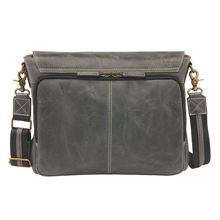 Distressed grey unisex concealed carry crossbody messenger bag in full grain buffalo leather with rich patina, RFID-blocking pocket, magnetic flap closure, and adjustable slash-resistant strap. Features a spacious main compartment and padded gun pocket compatible with Glock 19, Sig P365, S&W M&P 2.0, and more.