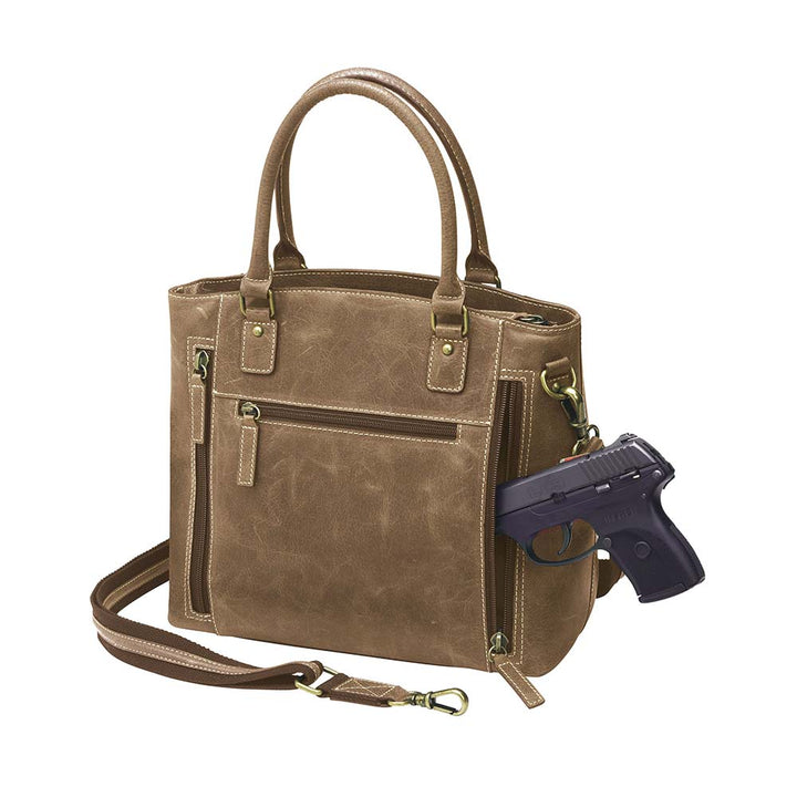 Bold distressed red full grain buffalo leather town tote with concealed carry functionality. Soft yet rugged vintage leather develops unique patina with everyday wear. Slash-resistant adjustable crossbody strap with padded gun compartment protects against imprinting. Designed for ambidextrous draw, multiple organizational pockets including secure zipper compartments. Includes Mernickle holster tested for compact and subcompact pistols. Perfect for confident, stylish concealed carry.
