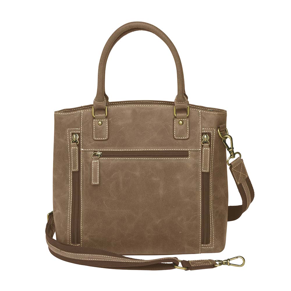 Distressed brown full grain buffalo leather town tote with concealed carry compartment. Vintage-inspired patina develops with use. Features reinforced slash-resistant shoulder strap, padded interior for gun protection, and dual top handles for versatile carry. Designed for ambidextrous draw, includes multiple pockets for phone, pepper spray, and essentials. Tested with popular pistols, equipped with Mernickle holster. Durable and stylish everyday concealed carry purse.