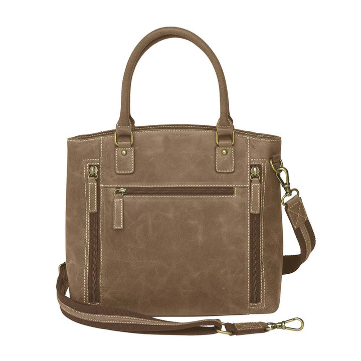 Distressed brown full grain buffalo leather town tote with concealed carry compartment. Vintage-inspired patina develops with use. Features reinforced slash-resistant shoulder strap, padded interior for gun protection, and dual top handles for versatile carry. Designed for ambidextrous draw, includes multiple pockets for phone, pepper spray, and essentials. Tested with popular pistols, equipped with Mernickle holster. Durable and stylish everyday concealed carry purse.