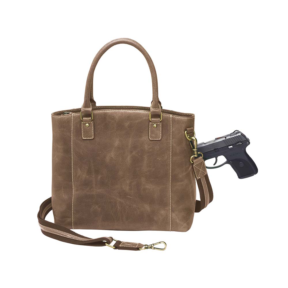 Distressed brown full grain buffalo leather town tote with concealed carry compartment. Vintage-inspired patina develops with use. Features reinforced slash-resistant shoulder strap, padded interior for gun protection, and dual top handles for versatile carry. Designed for ambidextrous draw, includes multiple pockets for phone, pepper spray, and essentials. Tested with popular pistols, equipped with Mernickle holster. Durable and stylish everyday concealed carry purse.