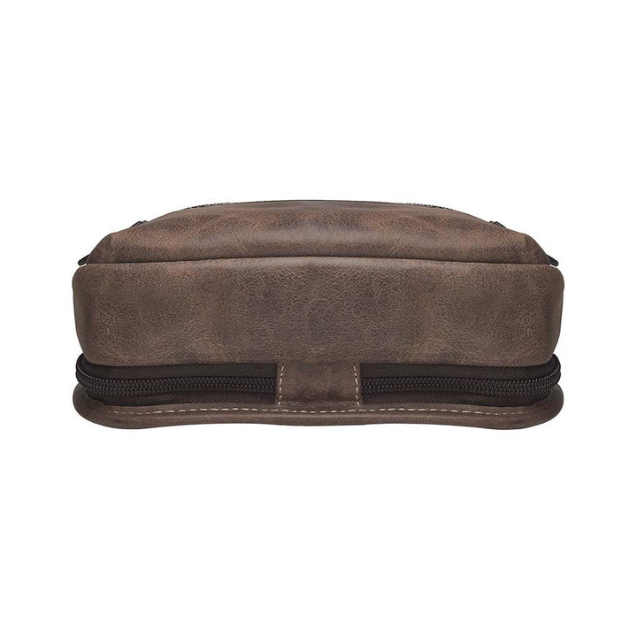 Distressed brown buffalo leather sling concealed carry backpack with tactical organization, RFID zip pocket, padded holster compartment for Glock 19, Sig P320, and HK VP9, slash-proof strap, and swing-front crossbody design with 3 exterior zip pockets and morale patch zone