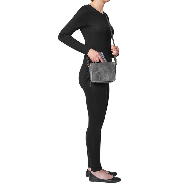Modern gray crossbody concealed carry organizer purse made of vintage tanned leather, with a discreet firearm compartment, lightweight design, and quick-access zippered opening.