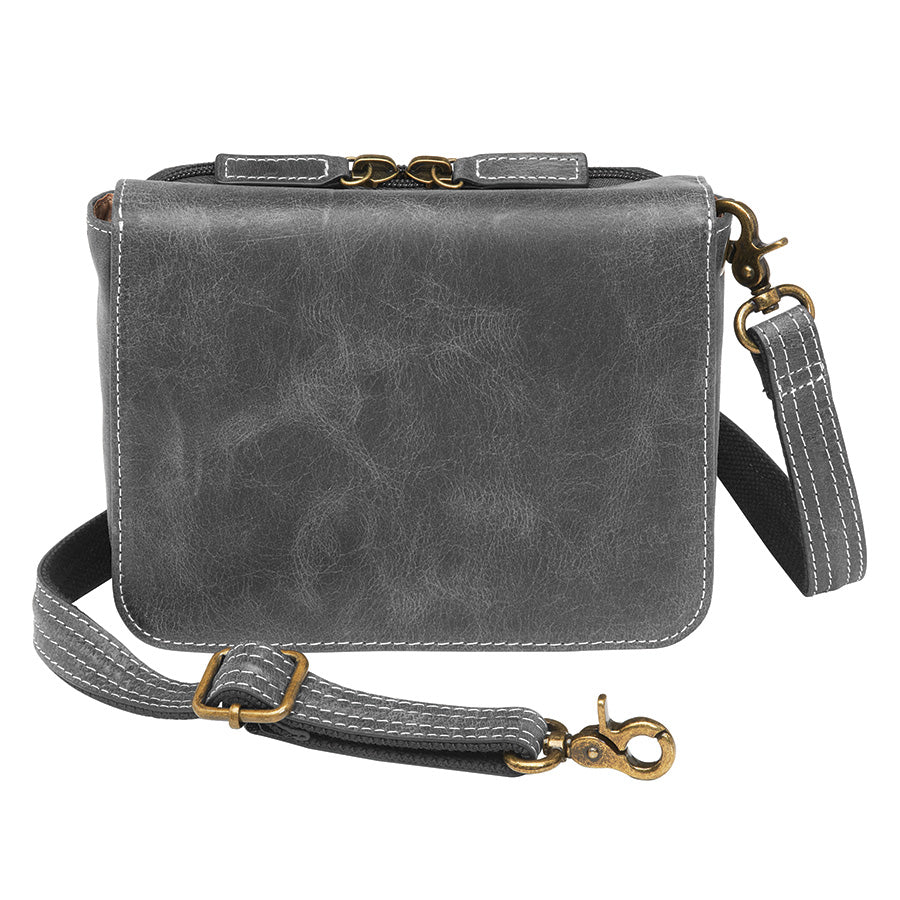 Modern gray crossbody concealed carry organizer purse made of vintage tanned leather, with a discreet firearm compartment, lightweight design, and quick-access zippered opening.