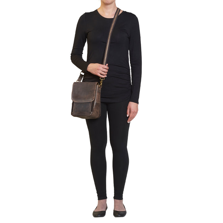 Model wearing GTM/CZY-80 Distressed Leather Crossbody Satchel from front angle highlighting soft distressed leather, flap closure with rare earth magnets, and accessible front zippered organizer