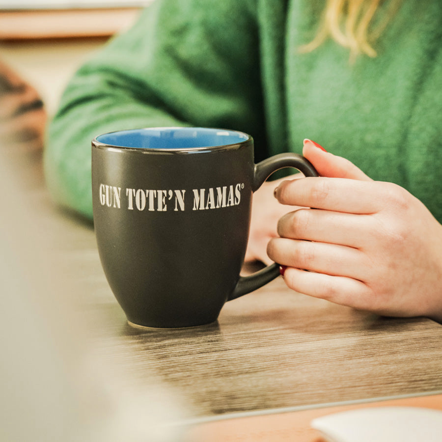 Professional girl in a offie with BISTRO Gun Tote’n Mamas mug with laser-etched logo – two-toned matte black and glossy blue, 16oz ceramic stoneware, dishwasher safe, free shipping