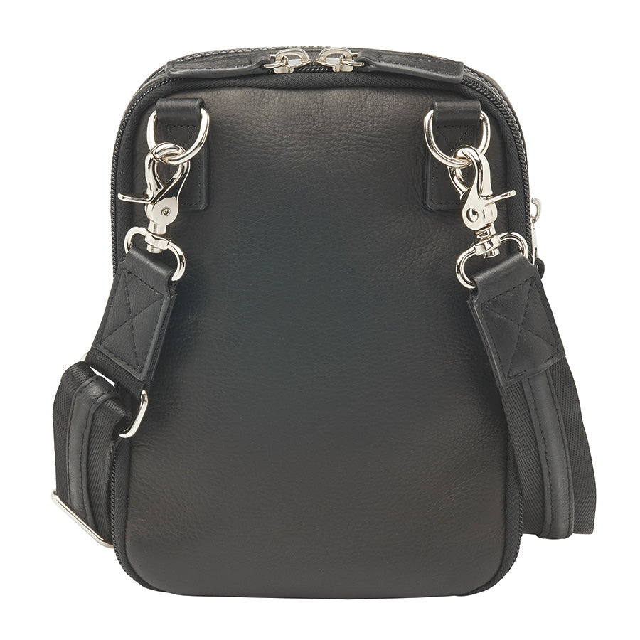 Compact camo-patterned crossbody concealed carry bag with black leather accents, slash-resistant strap, RFID protection, and a secure zippered front pocket for discreet firearm storage