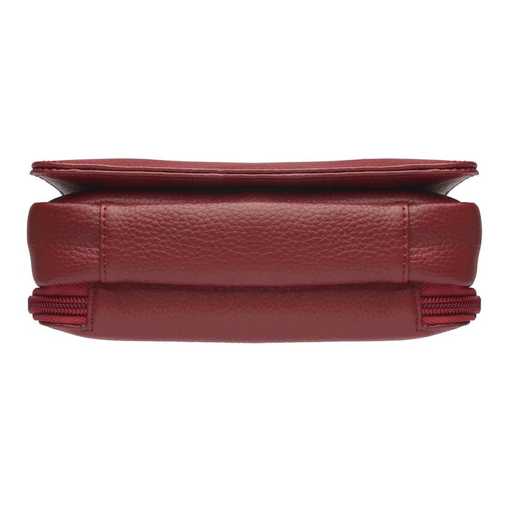 Red compact crossbody organizer concealed carry purse made from soft American cowhide with pebble grain texture, lightweight and durable, featuring RFID-protected zippered pocket, rare earth magnetic flap closure, slash-resistant adjustable shoulder strap with steel wire reinforcement, padded gun compartment, includes mini Mernickle holster, designed for left and right-handed use.