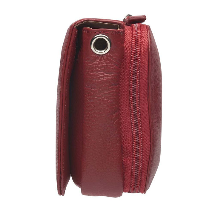 Red compact crossbody organizer concealed carry purse made from soft American cowhide with pebble grain texture, lightweight and durable, featuring RFID-protected zippered pocket, rare earth magnetic flap closure, slash-resistant adjustable shoulder strap with steel wire reinforcement, padded gun compartment, includes mini Mernickle holster, designed for left and right-handed use.