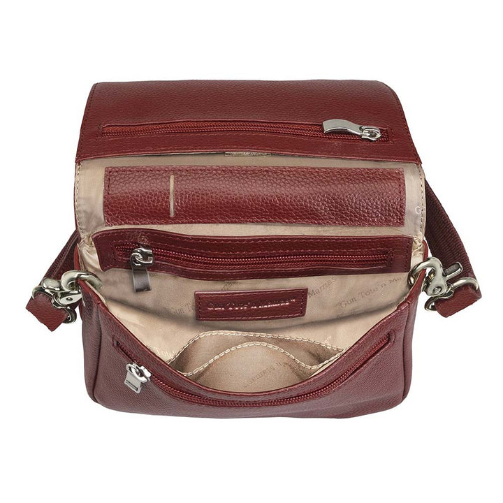 Red compact crossbody organizer concealed carry purse made from soft American cowhide with pebble grain texture, lightweight and durable, featuring RFID-protected zippered pocket, rare earth magnetic flap closure, slash-resistant adjustable shoulder strap with steel wire reinforcement, padded gun compartment, includes mini Mernickle holster, designed for left and right-handed use.