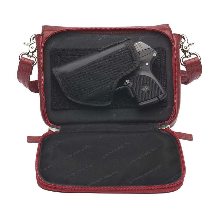 Red compact crossbody organizer concealed carry purse made from soft American cowhide with pebble grain texture, lightweight and durable, featuring RFID-protected zippered pocket, rare earth magnetic flap closure, slash-resistant adjustable shoulder strap with steel wire reinforcement, padded gun compartment, includes mini Mernickle holster, designed for left and right-handed use.