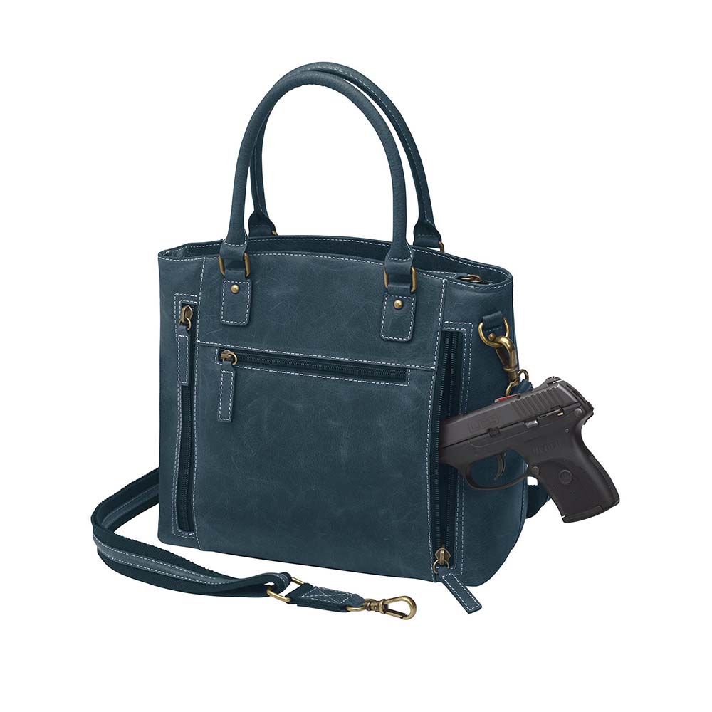 Rich distressed blue leather town tote purse with concealed carry pocket. Made from vintage full grain buffalo leather with soft, worn-in feel that deepens over time. Slash-resistant adjustable crossbody strap with padded gun compartment to prevent imprinting. Includes front and rear zippered pockets, designed for left or right hand draw. Comes with trusted Mernickle holster, perfect for discreet everyday carry with style and durability.