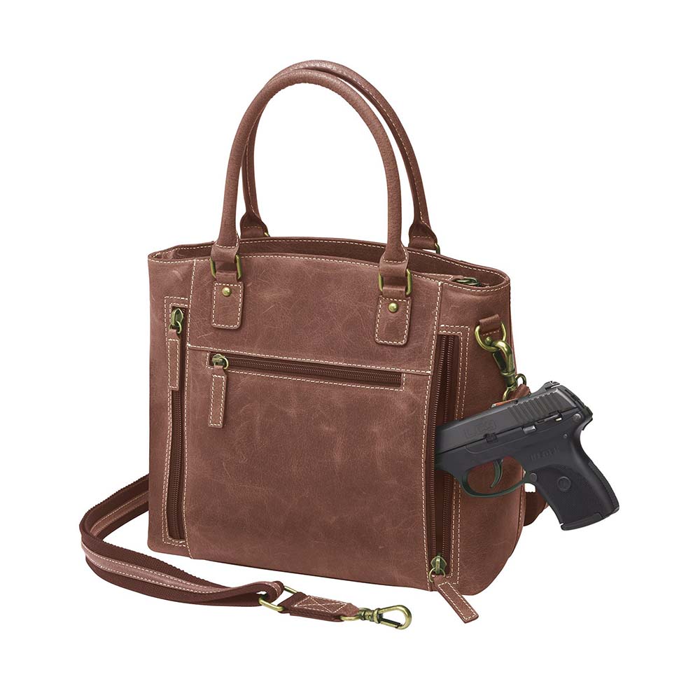 Bold distressed red full grain buffalo leather town tote with concealed carry functionality. Soft yet rugged vintage leather develops unique patina with everyday wear. Slash-resistant adjustable crossbody strap with padded gun compartment protects against imprinting. Designed for ambidextrous draw, multiple organizational pockets including secure zipper compartments. Includes Mernickle holster tested for compact and subcompact pistols. Perfect for confident, stylish concealed carry.