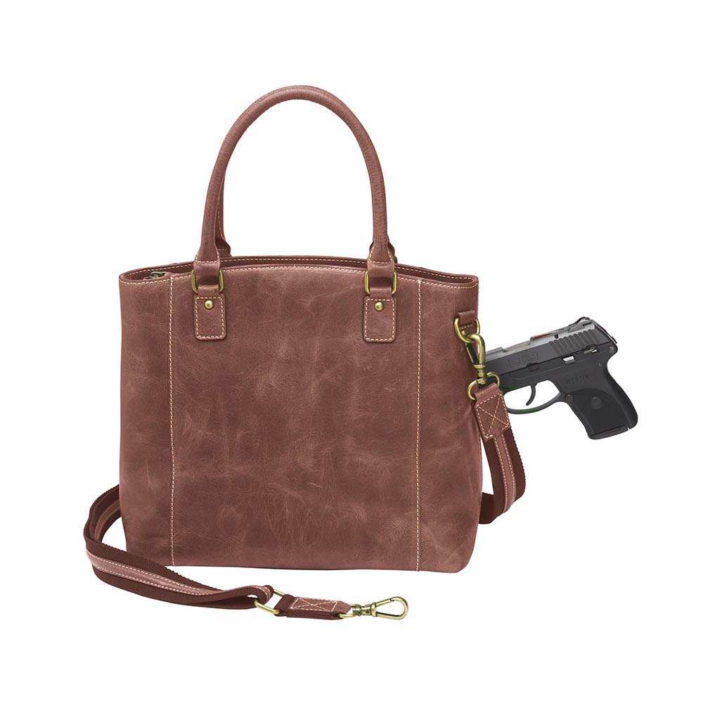 Bold distressed red full grain buffalo leather town tote with concealed carry functionality. Soft yet rugged vintage leather develops unique patina with everyday wear. Slash-resistant adjustable crossbody strap with padded gun compartment protects against imprinting. Designed for ambidextrous draw, multiple organizational pockets including secure zipper compartments. Includes Mernickle holster tested for compact and subcompact pistols. Perfect for confident, stylish concealed carry.