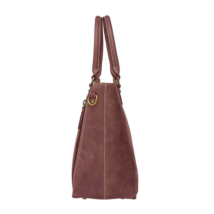 Bold distressed red full grain buffalo leather town tote with concealed carry functionality. Soft yet rugged vintage leather develops unique patina with everyday wear. Slash-resistant adjustable crossbody strap with padded gun compartment protects against imprinting. Designed for ambidextrous draw, multiple organizational pockets including secure zipper compartments. Includes Mernickle holster tested for compact and subcompact pistols. Perfect for confident, stylish concealed carry.