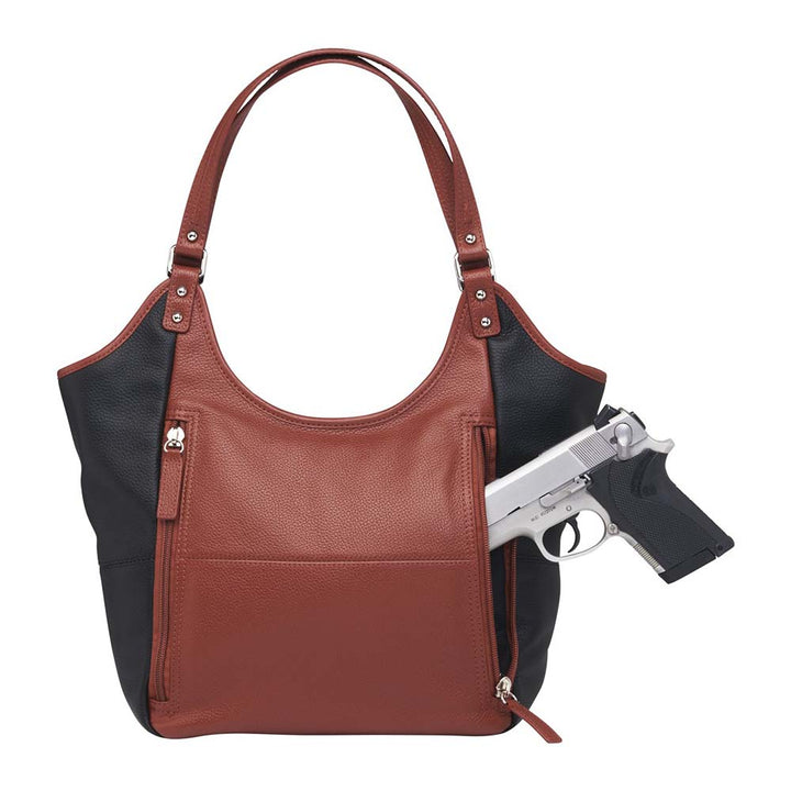 Elegant cinnamon and black leather concealed carry tote with secure underarm fit, reinforced slash-resistant handles, and hidden padded holster pocket. Spacious interior fits iPad, personal items, and compact handguns like Sig P365 or Glock 19.