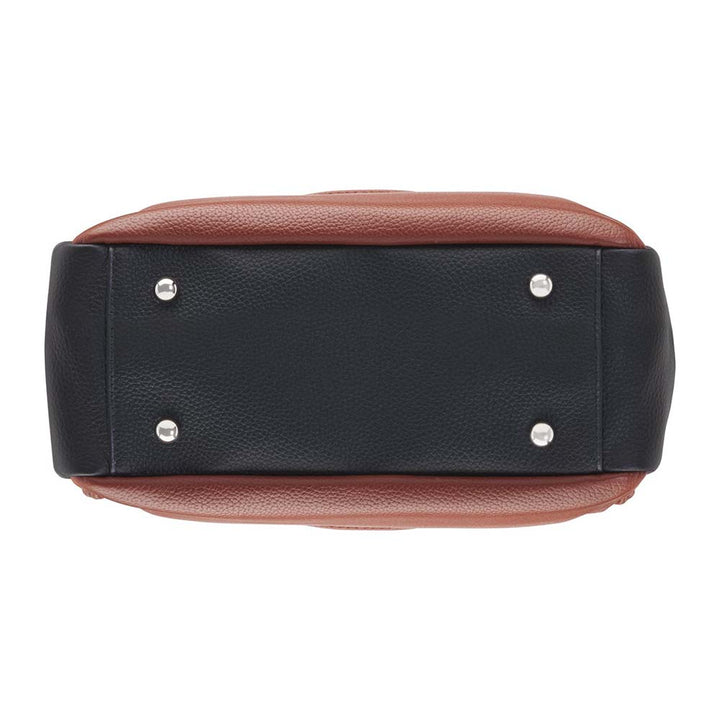 Elegant cinnamon and black leather concealed carry tote with secure underarm fit, reinforced slash-resistant handles, and hidden padded holster pocket. Spacious interior fits iPad, personal items, and compact handguns like Sig P365 or Glock 19.