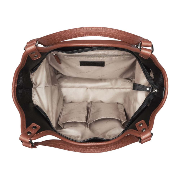 Elegant cinnamon and black leather concealed carry tote with secure underarm fit, reinforced slash-resistant handles, and hidden padded holster pocket. Spacious interior fits iPad, personal items, and compact handguns like Sig P365 or Glock 19.