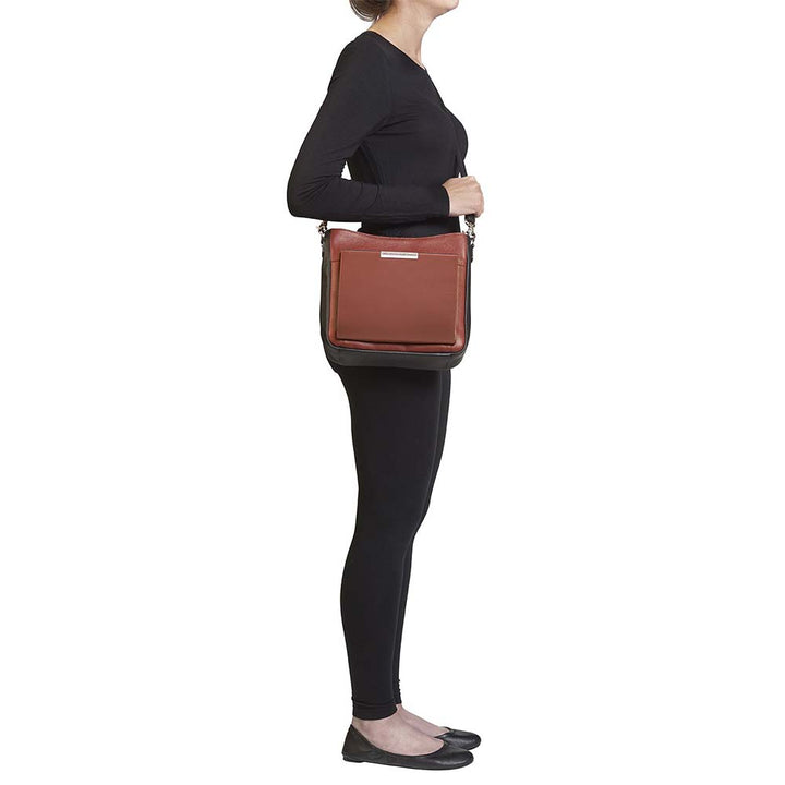 Cinnamon brown concealed carry crossbody purse with wallet organizer – slim leather gun bag for women with RFID protection, rare earth magnetic closure, slash-resistant strap, and ambidextrous draw. Fits compact firearms like Glock 26, Sig P365, and M&P Shield.