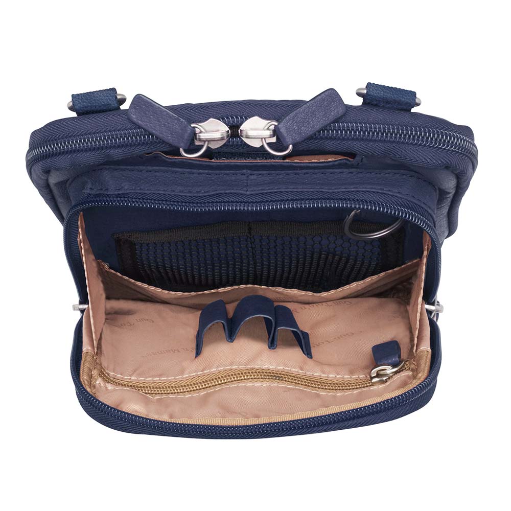 Indigo blue concealed carry crossbody shoulder pouch for women and men, designed to discreetly fit 1911 and compact pistols like Glock 19 and M&P Shield, features padded gun compartment with top, side, and angled draw, RFID-protected interior, full-grain American cowhide with matte finish, slash-resistant strap, three-way zip opening, multiple storage pockets, and Mernickle holster for right or left-hand draw.