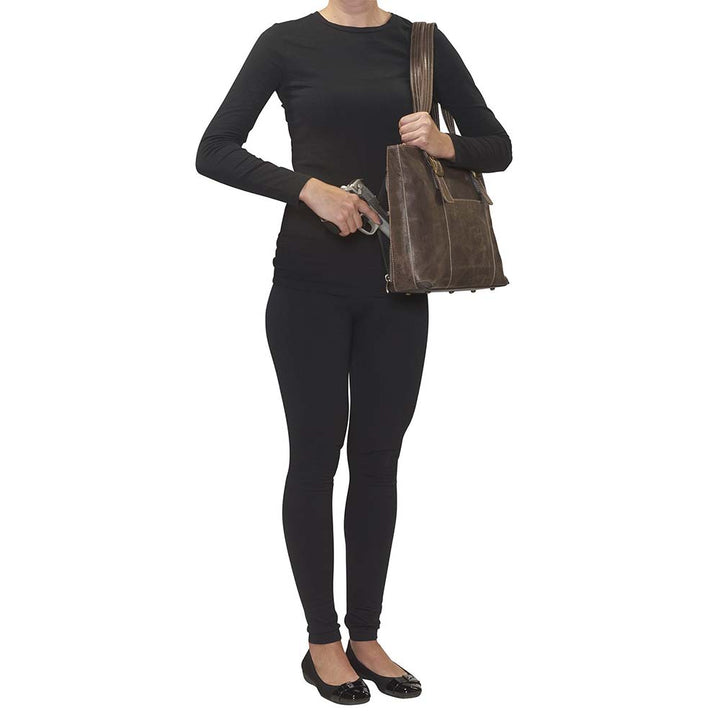 Distressed vintage buffalo leather shoulder portfolio concealed carry purse with slash-resistant double shoulder straps, patent-pending CCW rear zippered compartment for left or right-hand draw, padded to prevent imprinting, includes Mernickle holster, fits iPads and small laptops, RFID-protected organizer, top zipper closure, and chrome feet for stability—ideal for office or everyday carry.