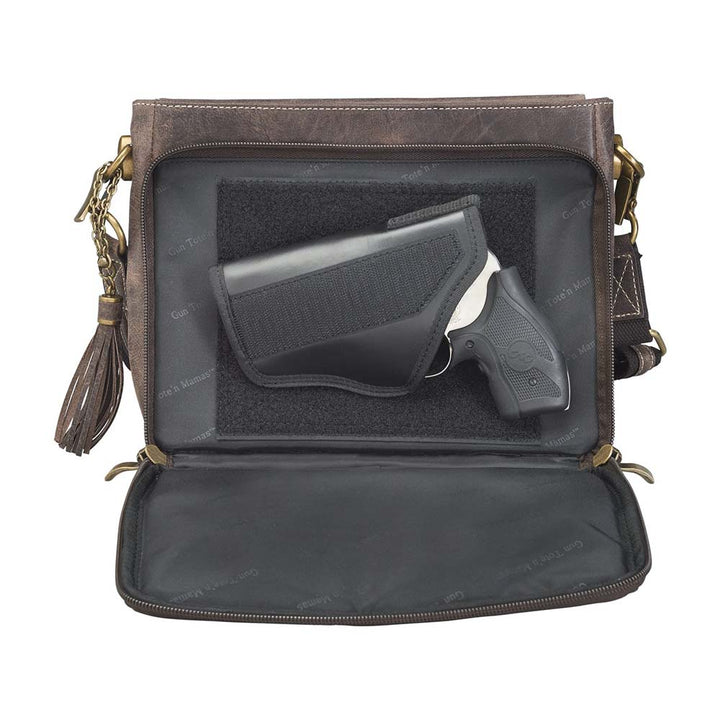 Timeless and tough — this brown distressed full-grain buffalo leather clutch gets better with age and wear. Designed to fit both left and right-handed carriers, it offers special padding to prevent imprinting and a slash-resistant shoulder strap reinforced with 11-ply steel wire for solid security.