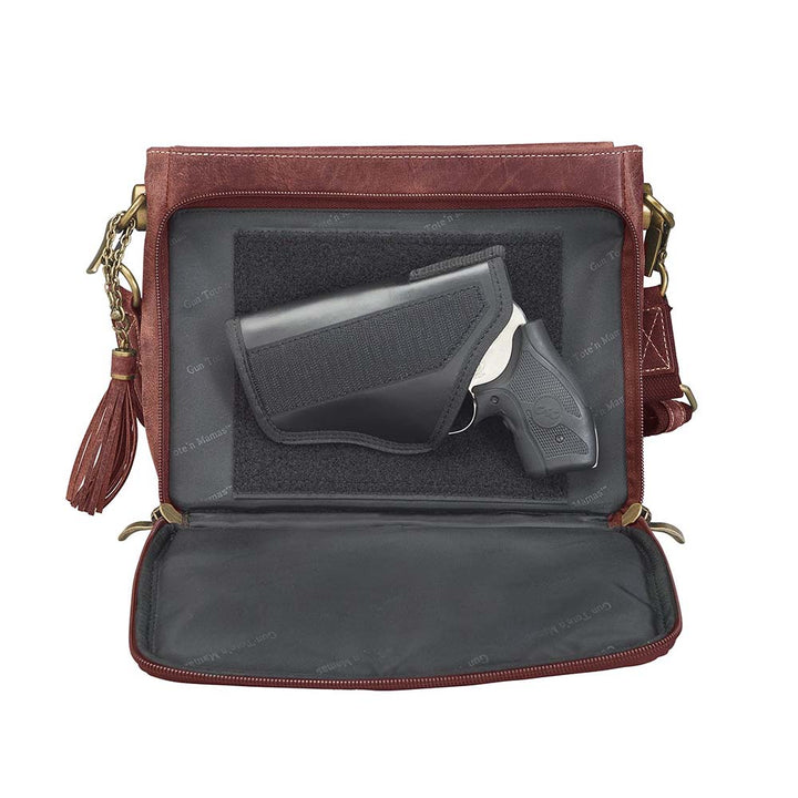 Timeless and tough — this brown distressed full-grain buffalo leather clutch gets better with age and wear. Designed to fit both left and right-handed carriers, it offers special padding to prevent imprinting and a slash-resistant shoulder strap reinforced with 11-ply steel wire for solid security.