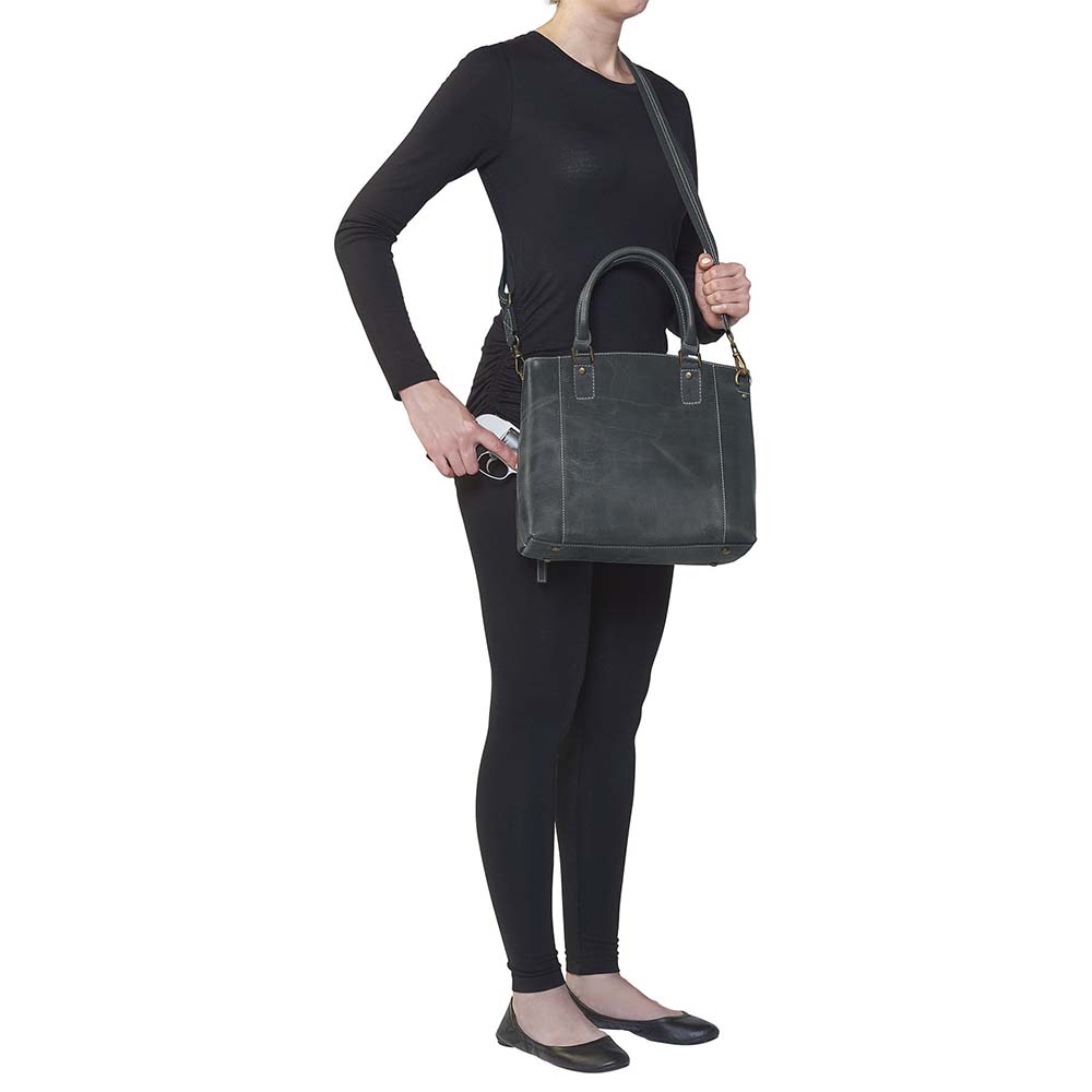 Sophisticated gray distressed full grain buffalo leather concealed carry town tote. Features vintage patina finish that ages gracefully, lightweight yet durable. Equipped with slash-resistant shoulder strap and padded interior for imprint protection. Designed for both left and right handed users, with ample storage including exterior and interior zip pockets. Comes with Mernickle standard holster, tested for reliable concealed carry performance.