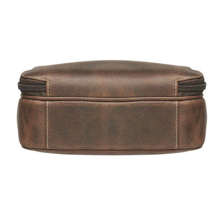 Distressed brown buffalo leather crossbody mail pouch with vintage patina, RFID protection, slash-resistant strap, and concealed carry holster compatible with left or right draw