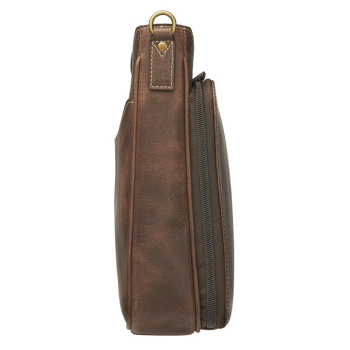 Distressed brown buffalo leather crossbody mail pouch with vintage patina, RFID protection, slash-resistant strap, and concealed carry holster compatible with left or right draw