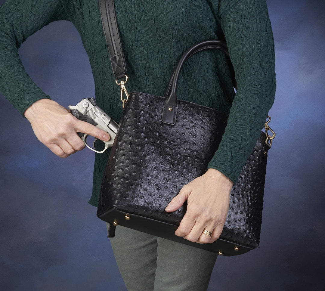 image of a gun going into a purse