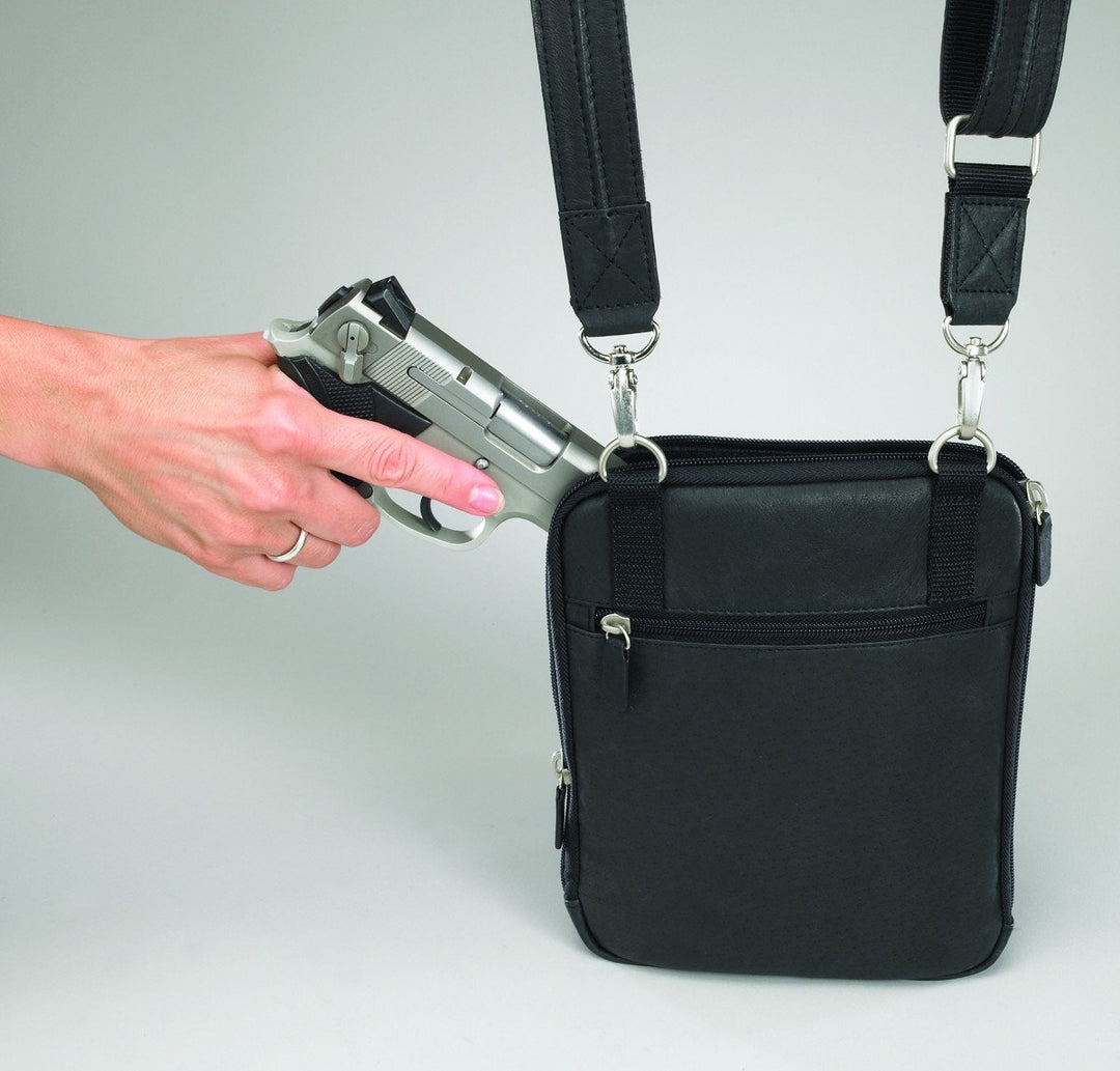 Gun Tote'n Mamas GTM-99 handbag with women reaching a concealed weapon out of it