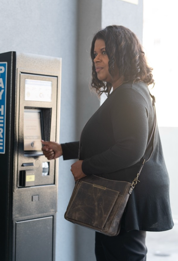 lady at a bank pulling out cash and with a leather purse