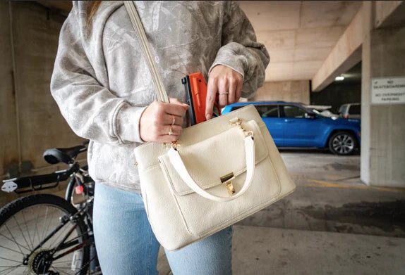 girl with ccw purse in a parking garage