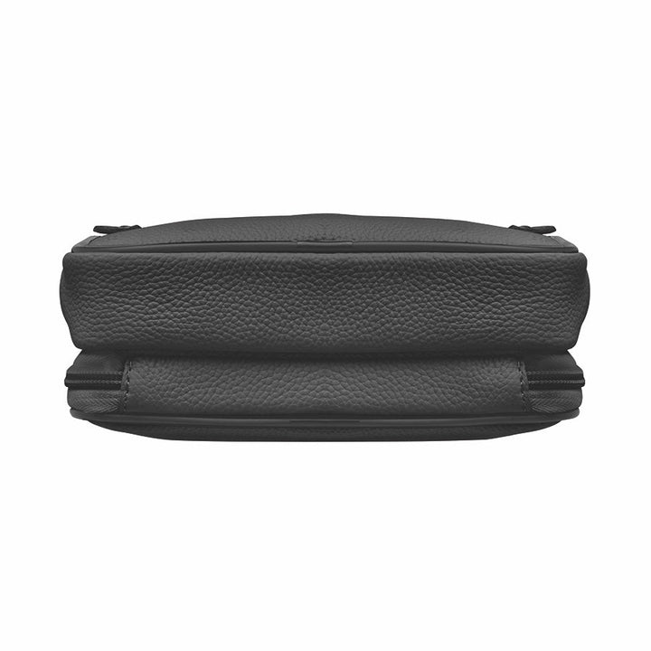 Black GTMoriginals sling waist pack with concealed carry design, cowhide leather, and adjustable strap on a plain background.
