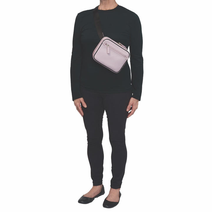 Lavender concealed carry sling waist pack made from soft pebbled American cowhide, with RFID zip pocket, crossbody or waist wear options, and discreet 3-sided access gun compartment with MINI holster compatibility.