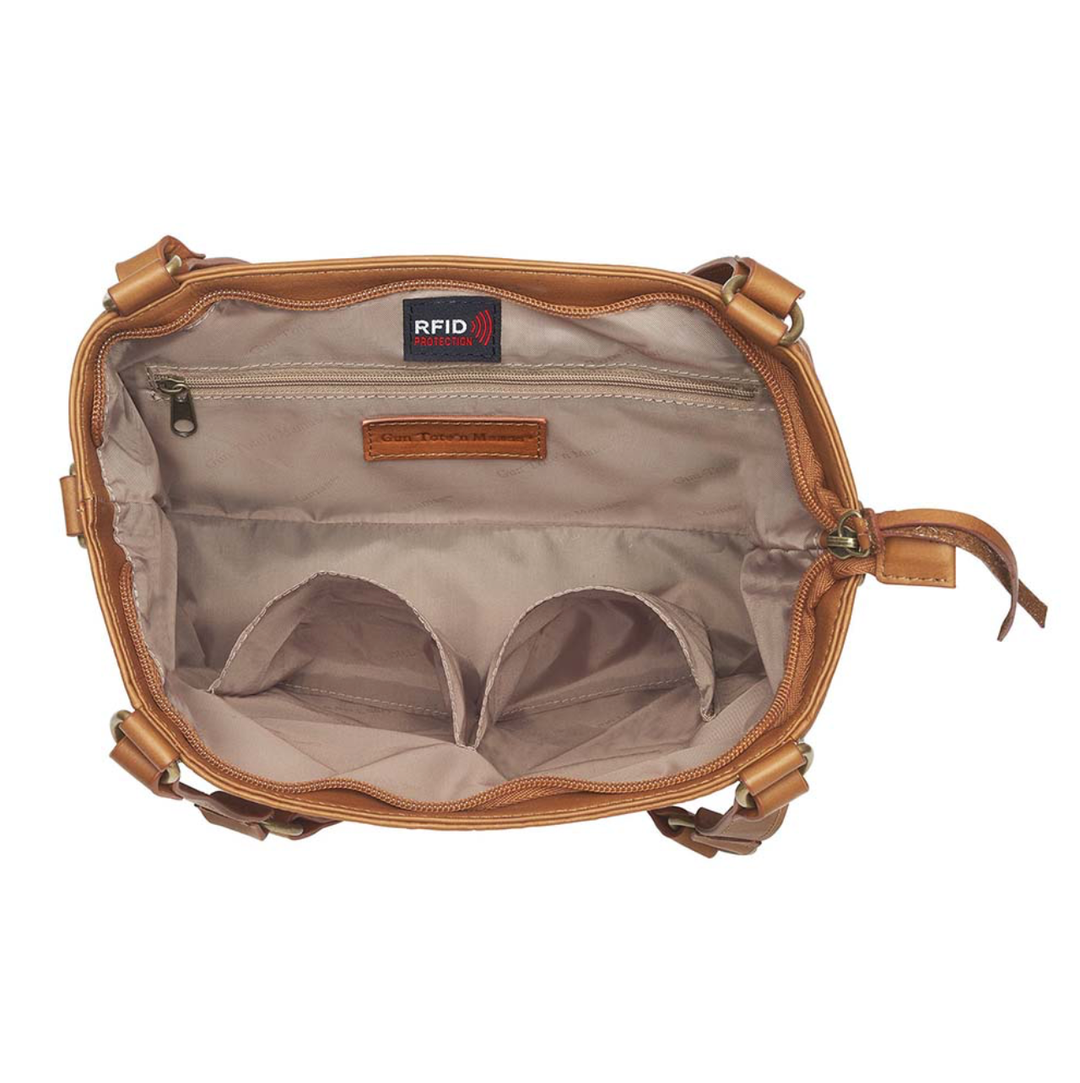 Tan concealed carry BOHO tote purse with top-access CCW compartment, symbolic butterfly and flower debossed leather, slash-proof straps, RFID-blocking zip pocket, and room for compact pistols like CZ P10, M&P Shield, and S&W EZ—each bag uniquely aged from natural tanning.