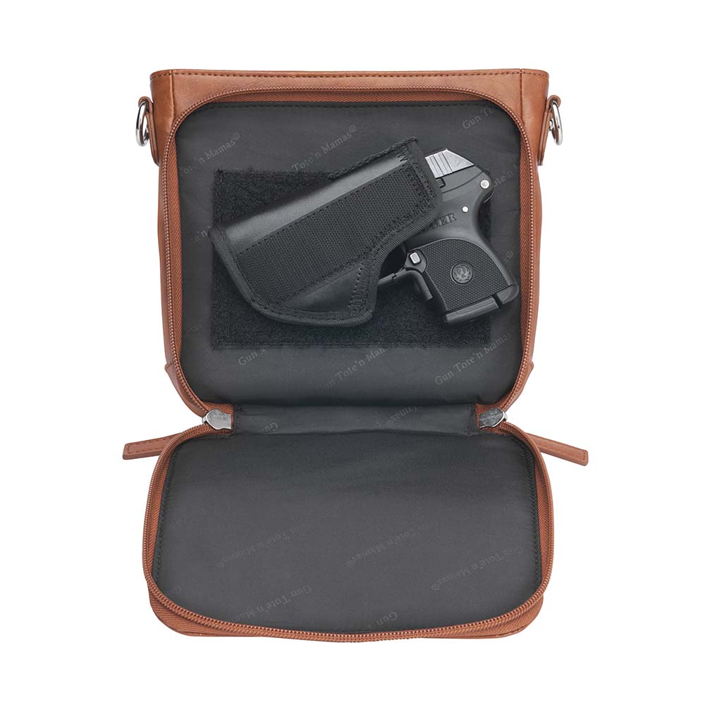 Tan concealed carry crossbody purse in washable American cowhide leather with RFID wallet organizer, slash-resistant steel cable strap, secure magnetic flap, triple-zippered gun access for compact firearms like Ruger LCP and Kahr 9, perfect for women seeking discreet protection and clean styling.