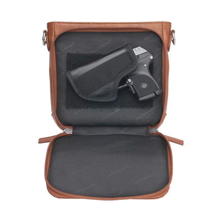 Tan concealed carry crossbody purse in washable American cowhide leather with RFID wallet organizer, slash-resistant steel cable strap, secure magnetic flap, triple-zippered gun access for compact firearms like Ruger LCP and Kahr 9, perfect for women seeking discreet protection and clean styling.