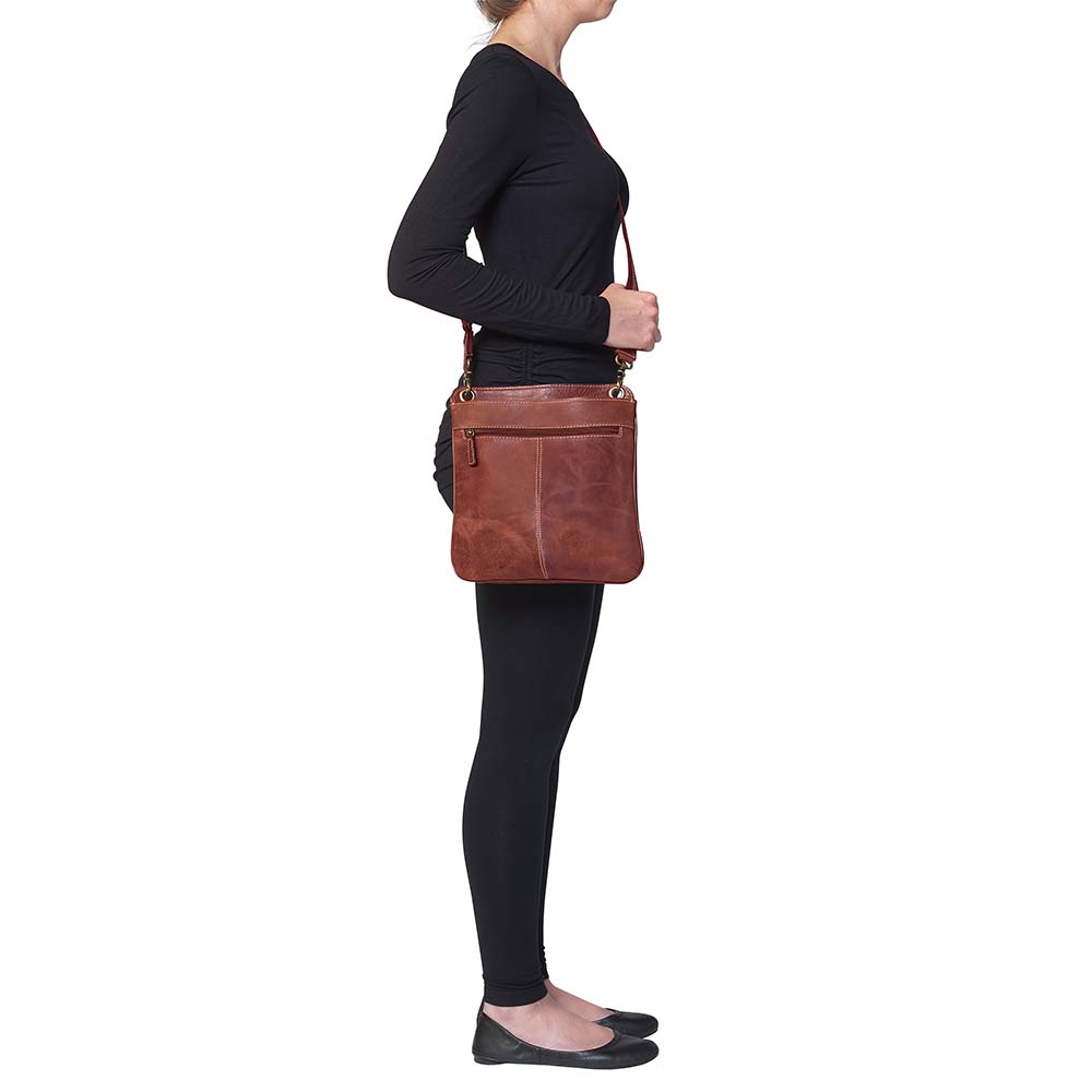 Vintage distressed buffalo leather concealed carry crossbody purse with adjustable slash-resistant strap, left and right-handed access, and a secure gun compartment designed for fast draw. Includes holster and fits compact handguns like S&W Shield, Ruger LCP, and Glock 42.