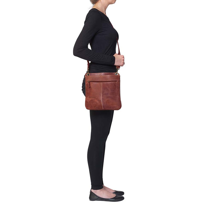 Vintage distressed buffalo leather concealed carry crossbody purse with adjustable slash-resistant strap, left and right-handed access, and a secure gun compartment designed for fast draw. Includes holster and fits compact handguns like S&W Shield, Ruger LCP, and Glock 42.