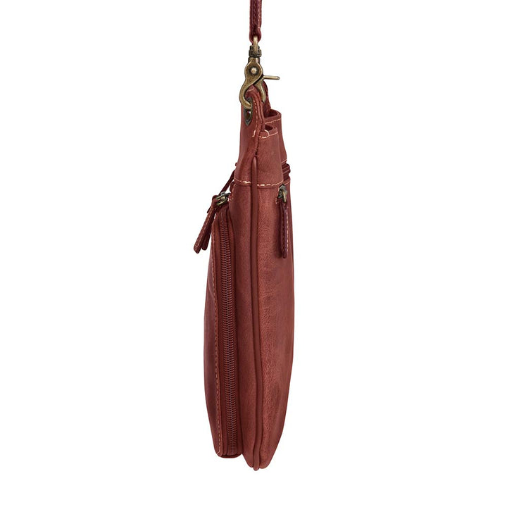 Vintage distressed buffalo leather concealed carry crossbody purse with adjustable slash-resistant strap, left and right-handed access, and a secure gun compartment designed for fast draw. Includes holster and fits compact handguns like S&W Shield, Ruger LCP, and Glock 42.