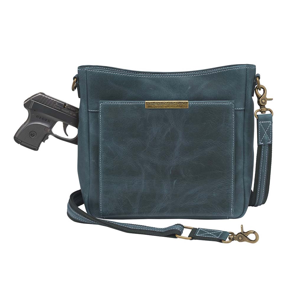 Distressed blue Gun Tote'N Mamas Slim Crossbody Concealed Carry Purse with front gun compartment and shoulder strap.
